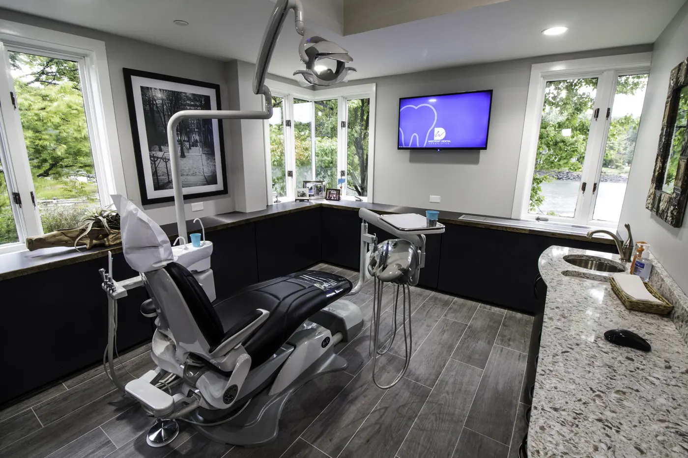 A treatment room at Westport Dental Associates, with windows on two sides looking onto the river.
