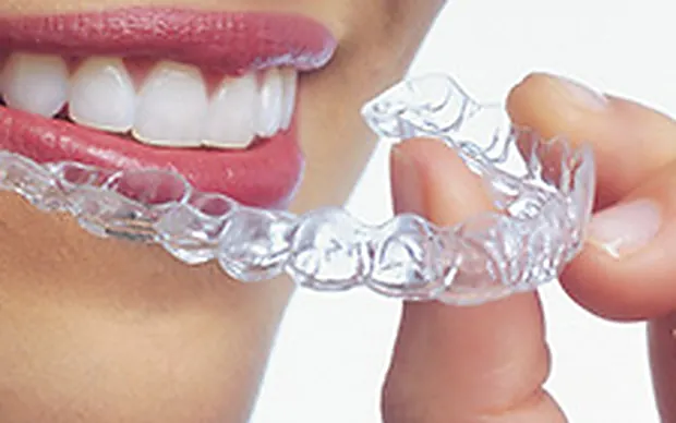A clear Invisalign aligner.